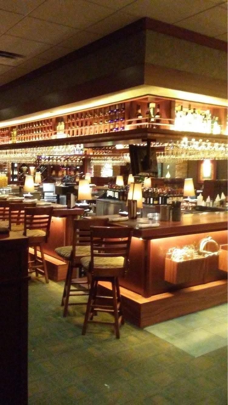 Restaurant bar with glowing LED lighting under the bar top and along the back shelving